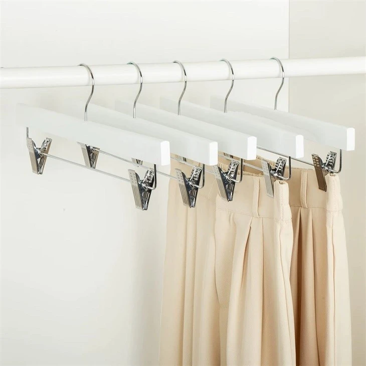 white wooden pant hangers